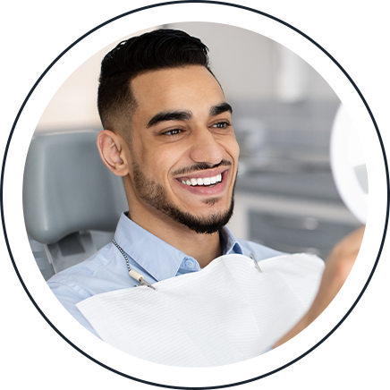 Smiling patient in the dental chair after a restorative dentistry treatment
