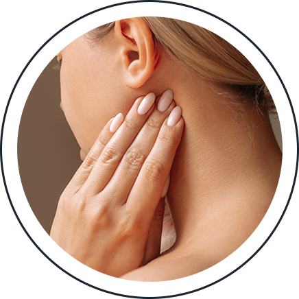 Woman holding her jaw in discomfort, a common symptom of TMJ disorder