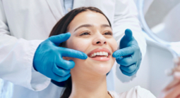 Dental hygienist examining a patient's smile during a teeth whitening visit